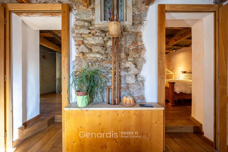 wooden floor, stone wall, wooden door, wooden cabinet, plant, basket, copper pipe, bed, bedding