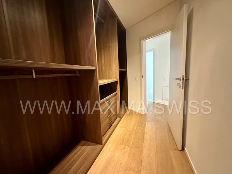 wooden wardrobe, wooden flooring, doorway to another room