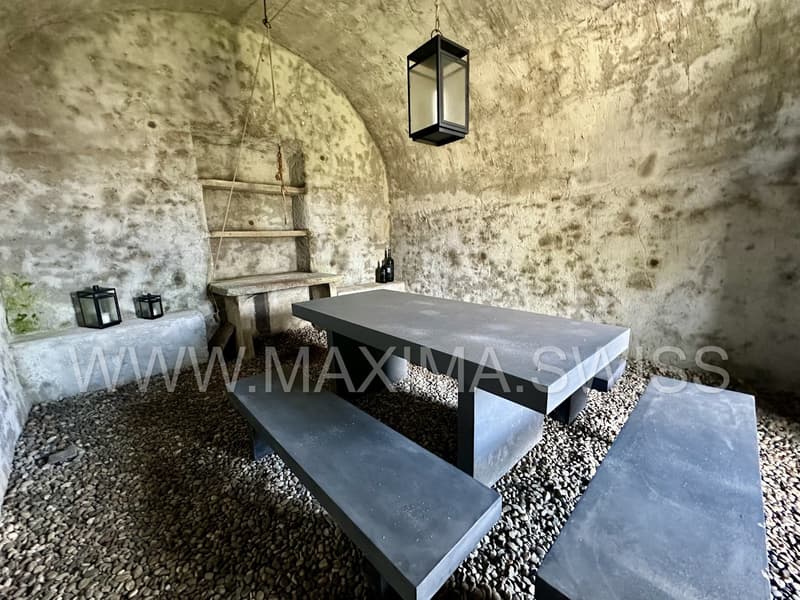 stone walls, stone bench, stone table, lamp, shelves, stone floor