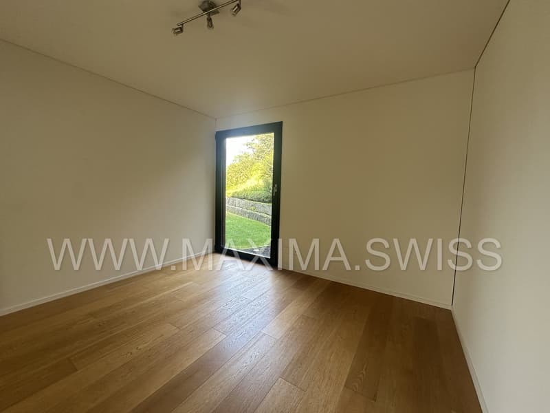 empty room, wooden floors, glass door, view of greenery