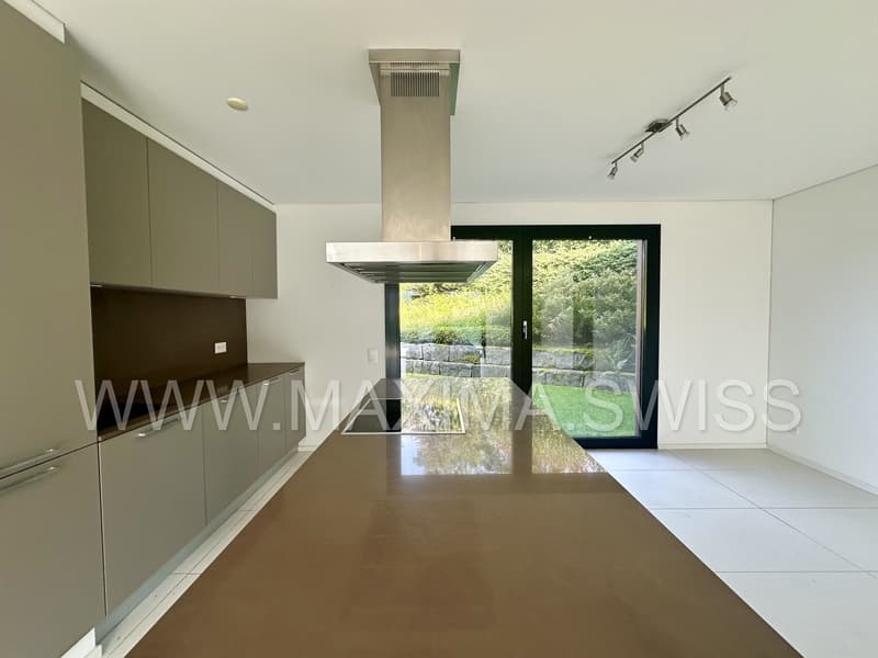 modern kitchen with large windows and view of the garden