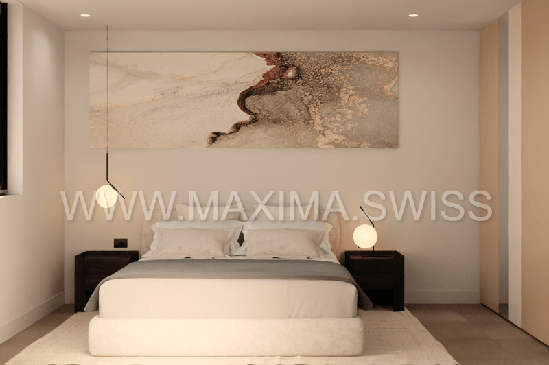 Large bed with gray bedding, two nightstands, two lamps, white rug on floor