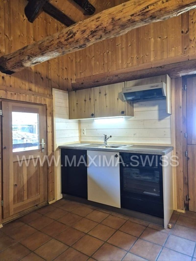 kitchen with wooden cabinets, tiled floor, sink, faucet, oven