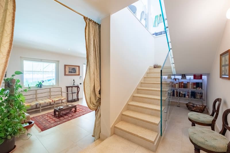modern house, white walls, glass staircase, beige tiles, wooden furniture, plants, rug, window