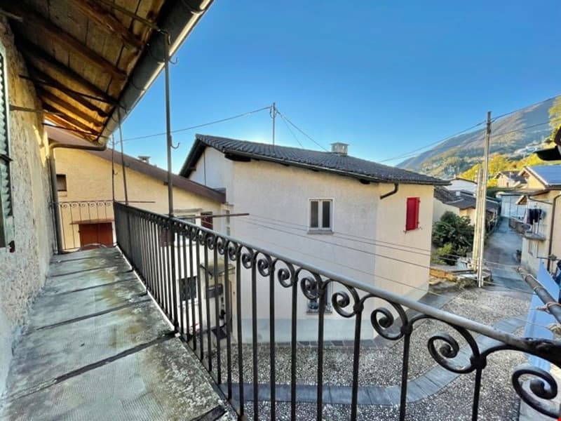 Black railing, stone floor, view to the street
