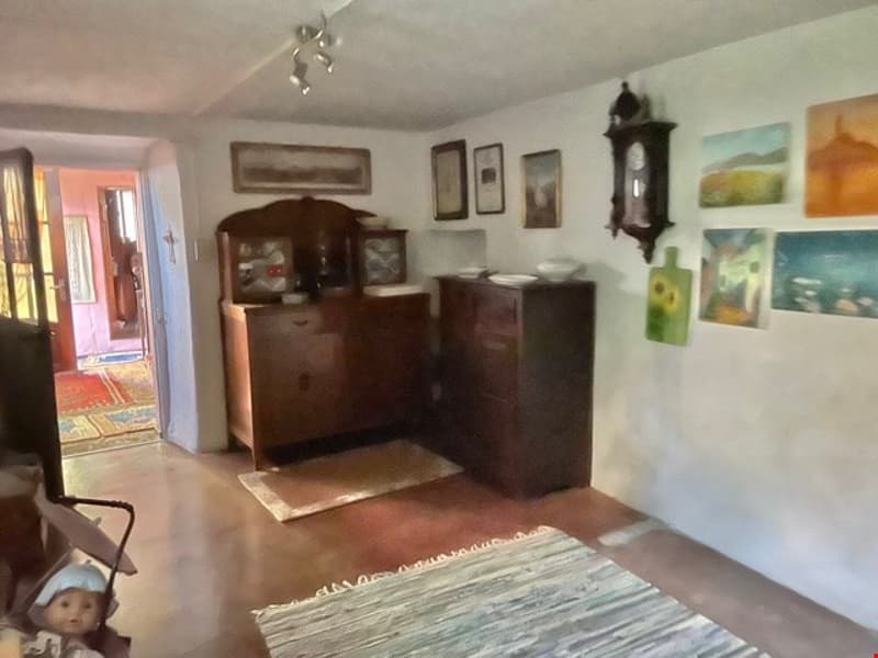room with wooden furniture, wooden floors, artwork, rug