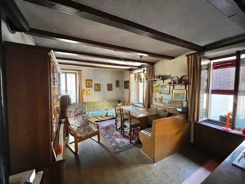 wooden furnishings, carpet, dining table, chairs, couch, shelf, pictures on the wall
