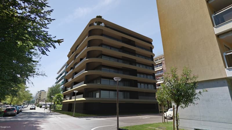 Modern design apartment building, multiple levels, balconies, glass windows, side parking, road, street lamps, greenery.