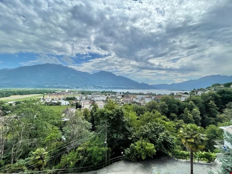Aerial view of the city, houses, mountains, greenery, clear sky, road, buildings