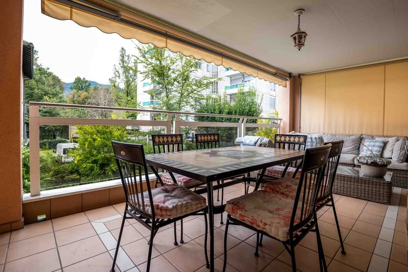 covered terrace with table and chairs, sofa, lamp