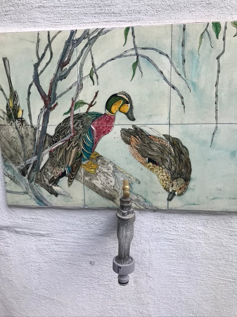 Decorative wall painting of ducks with water tap attached