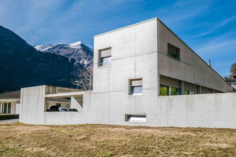 concrete house with modern architecture, mountain view, car garage