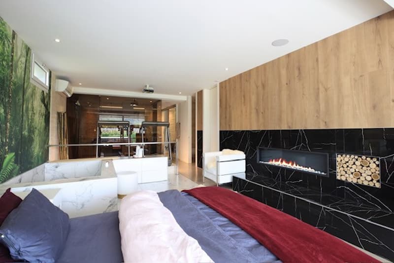 Marble floor, fireplace, bathtub, double bed, chairs, pillows