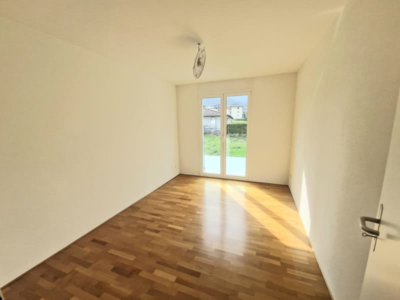 empty room, wooden floor, sliding glass door, white walls, sunny area, hanging fan