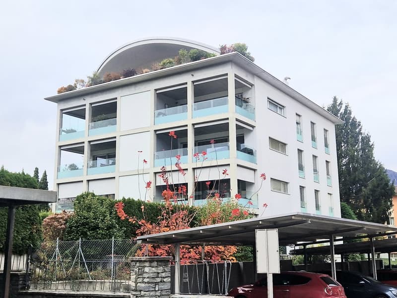 modern white apartment building, balconies, terraces, car parking under roof