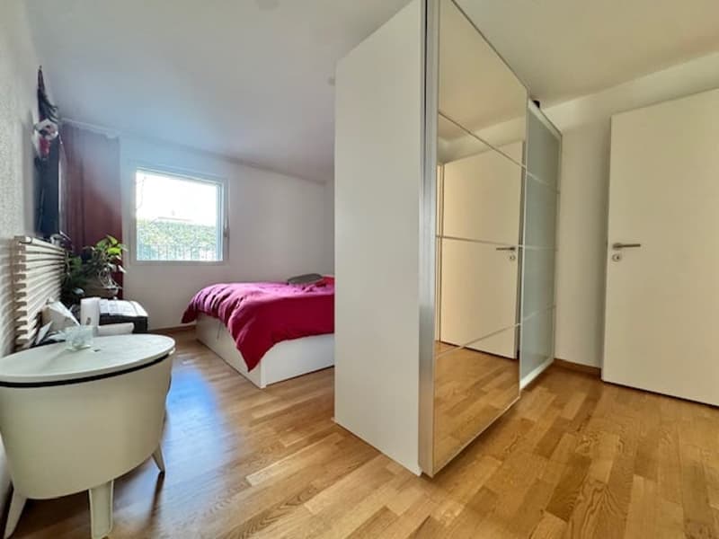 Bedroom with bed, nightstand, and window with curtains