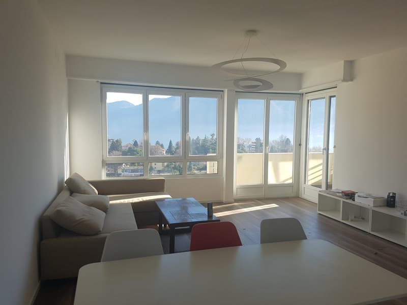 sofa, coffee table, 3 chairs, balcony doors, floor to ceiling windows