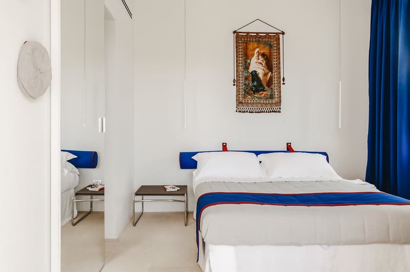 Bedroom with a bed, nightstands, and a wall decoration