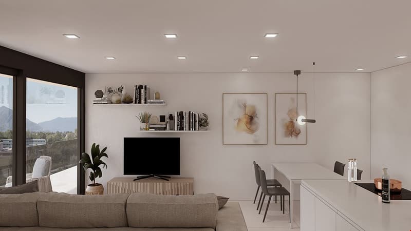 Spacious living room with large windows offering a scenic view, modern minimalist decor with neutral colors, floating shelves displaying decorative items, TV mounted on the wall, dining table and chairs in the adjacent area