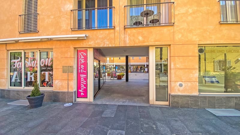 orange building, entrance, signboard, balcony, potted plant, tiled ground