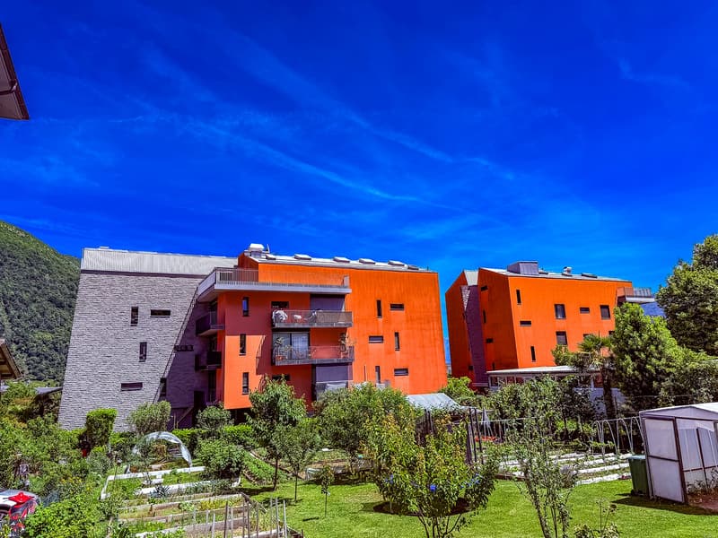 modern architecture, three units, terracotta and gray colored facade, multiple balconies