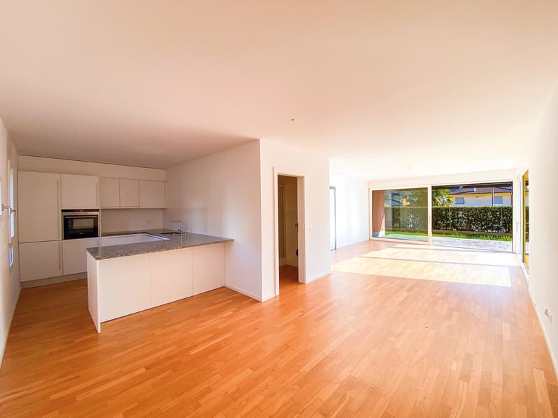 modern kitchen with island, white cabinets, granite countertop, built-in oven, large windows, wooden floor