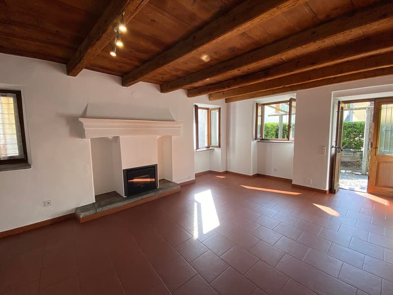 wooden ceiling, brown floor, fireplace, 3 windows, doors