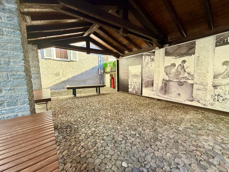 cobblestone floor, wooden benches, roof structure, brick wall, large wall image