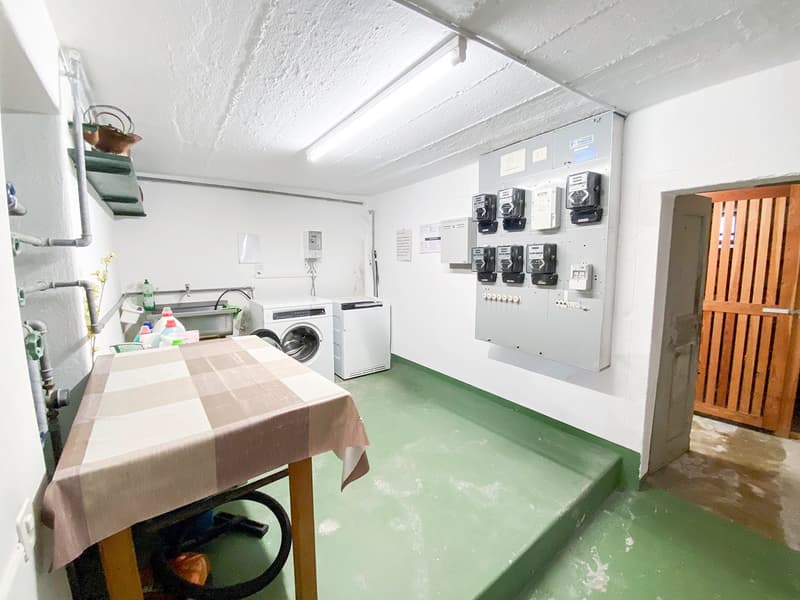utility room with washing machines, a table, and utility items