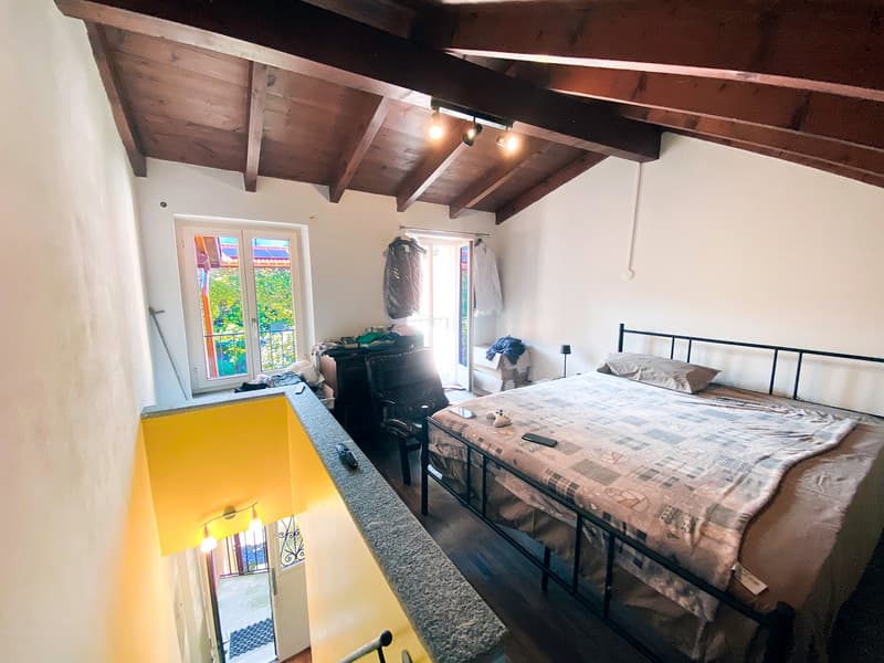 Single bed, clothes hanging, ceiling lamp, floor-to-ceiling window, yellow railing