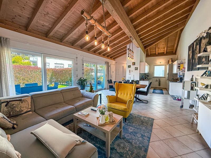 living room with exposed wooden beams, light fixtures, sofa, armchair, coffee table, floor tiles, glass windows, table, chairs