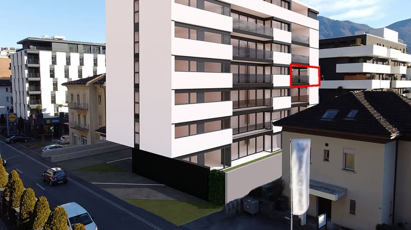 White building, 5 floors, balcony on each floor, parking lot, surrounding buildings