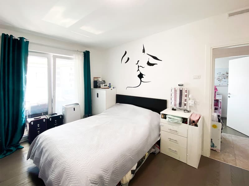 Single bed, bedside table, white cabinets, wall mural, curtains, windows