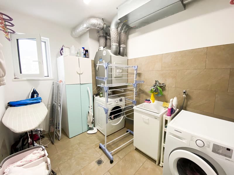 washer, dryer, sink, ironing board, storage cabinets