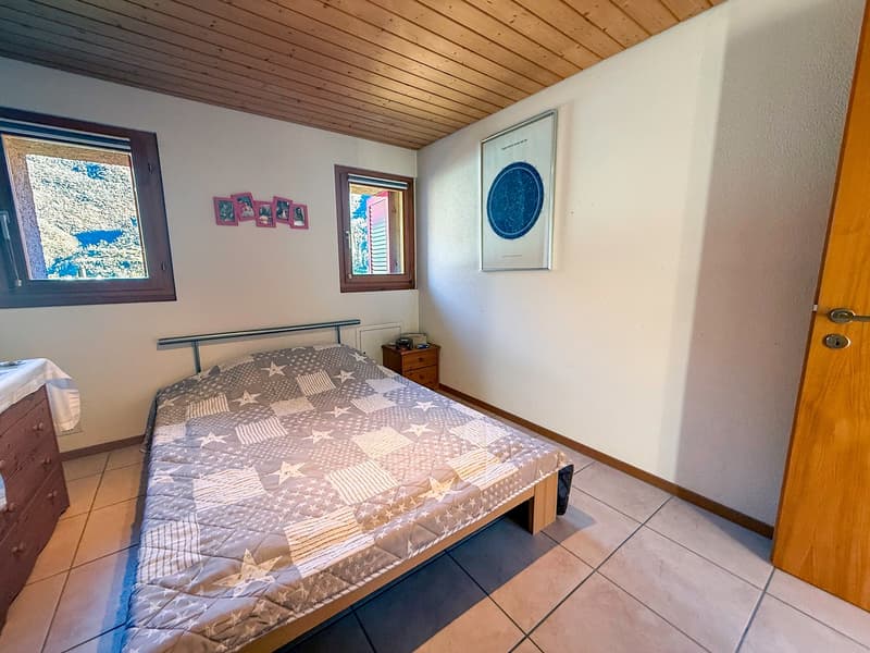 single bed, bedside table, wooden cupboard, 2 windows