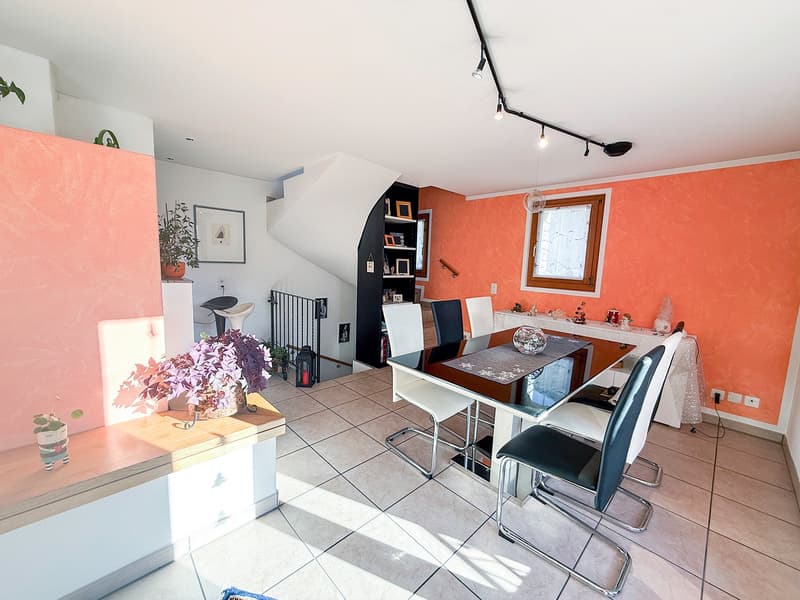 dining table with four chairs, staircase, plants, tiled floor, wall-mounted lights, window