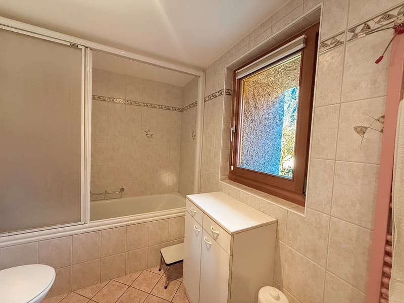 bathroom with a shower, bathtub, toilet, and cabinet with drawers