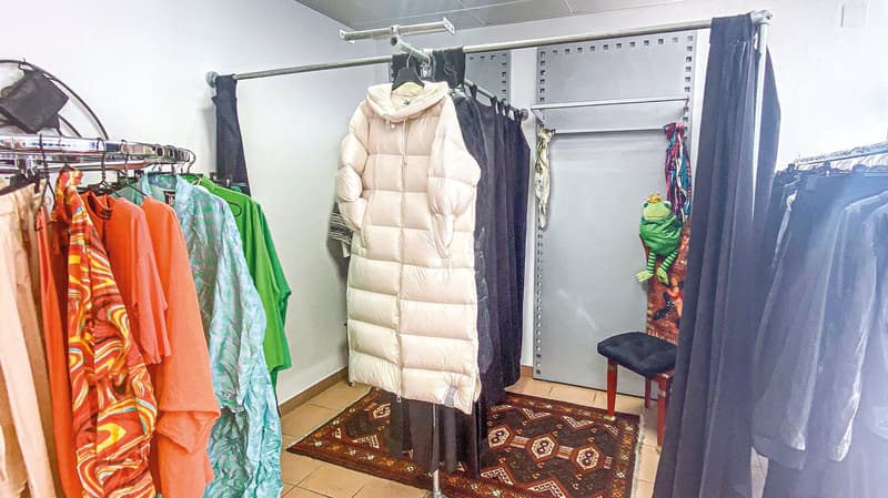walk-in closet with racks and floor to ceiling wardrobes, with carpets