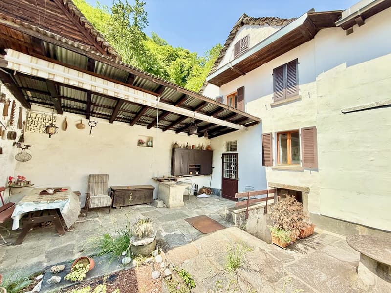 outdoor dining table, bench, fireplace, potted plants, shed