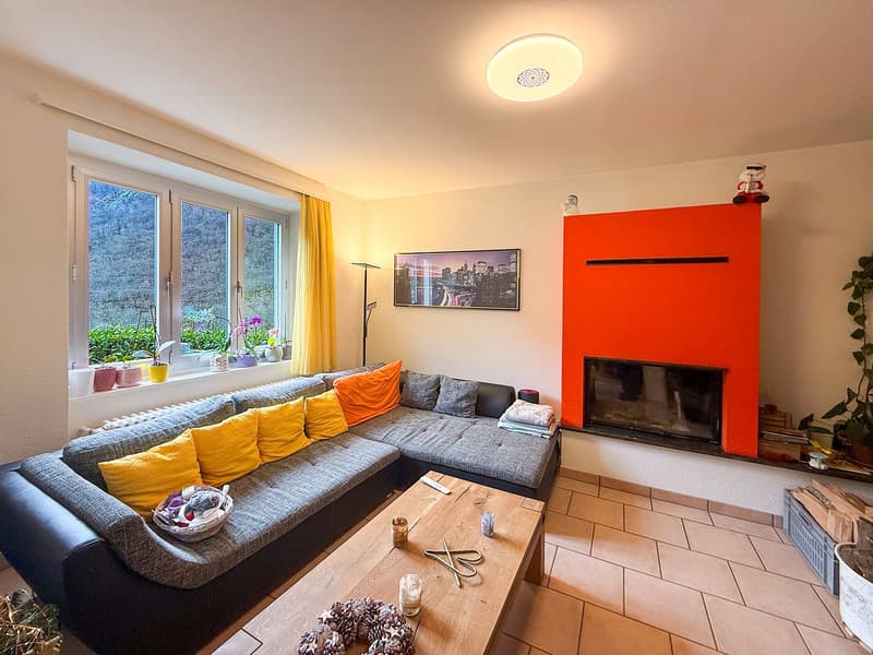 Large L-shaped sofa, fireplace, coffee table, floor lamp, painting, large windows