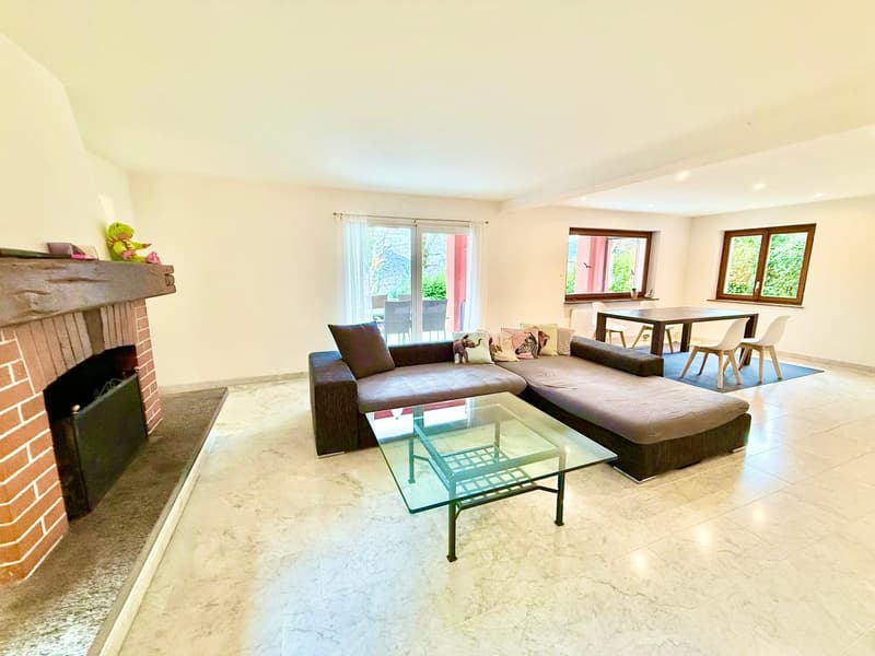 white walls, fireplace, large L shaped couch, coffee table, white ceiling