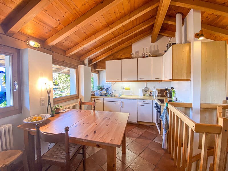 kitchen with dining area, wooden ceiling, wooden table, chairs, white cabinets, white appliances, radiator, windows