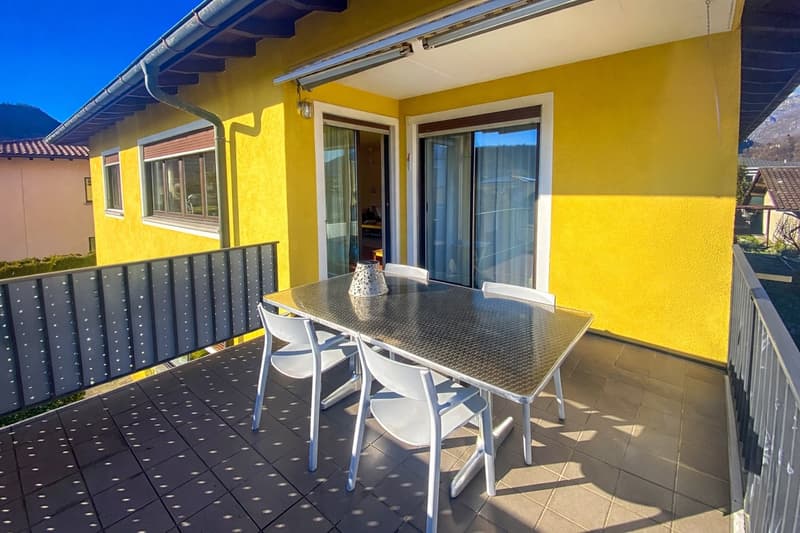 yellow wall, metal table, white chairs, metal railing, metal fence