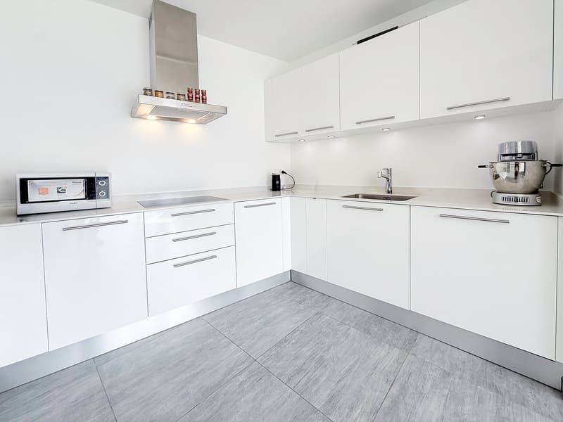 modern kitchen, white cabinets, gray tiled floor, stainless steel appliances, microwave, sink, faucet, coffee machine