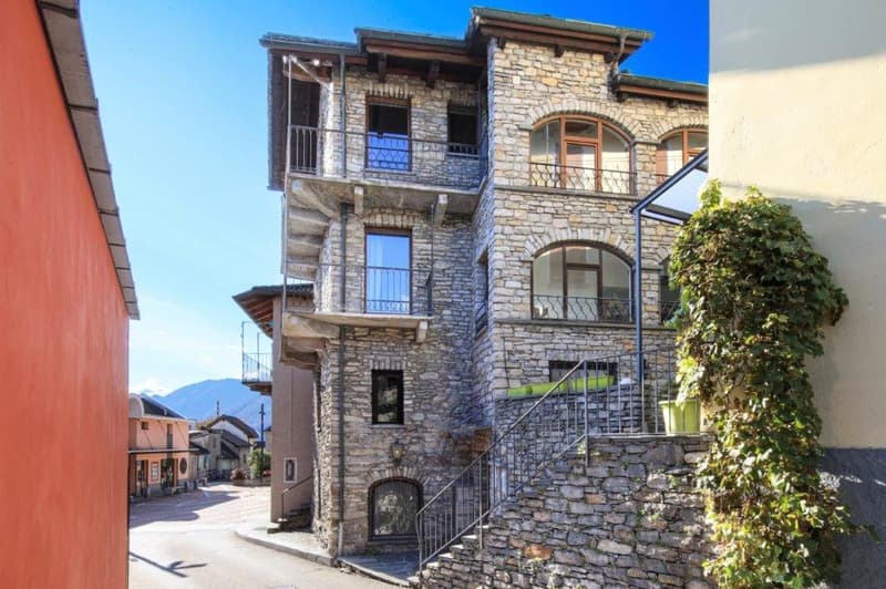 Stone exterior, multistory, several balconies, street view, steep slope