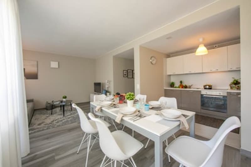 Modern kitchen with modern appliances and a dining area.