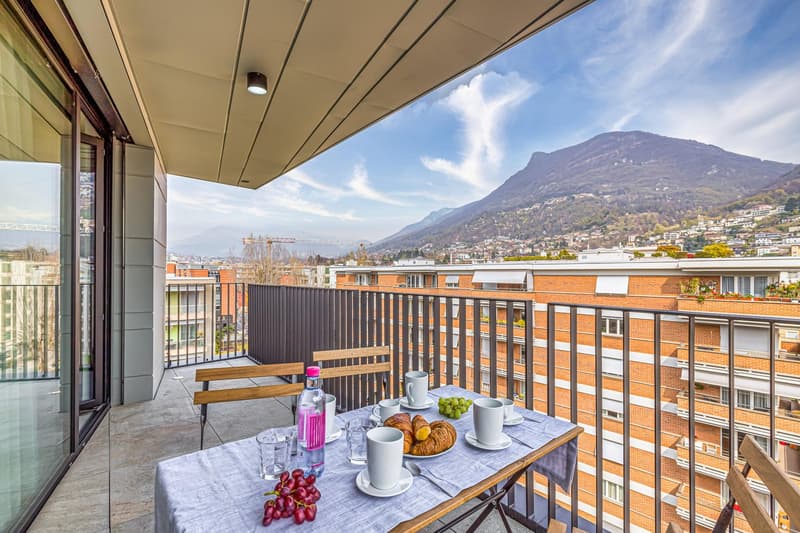 wooden tables and chairs, railings, mountain view, clear sky
