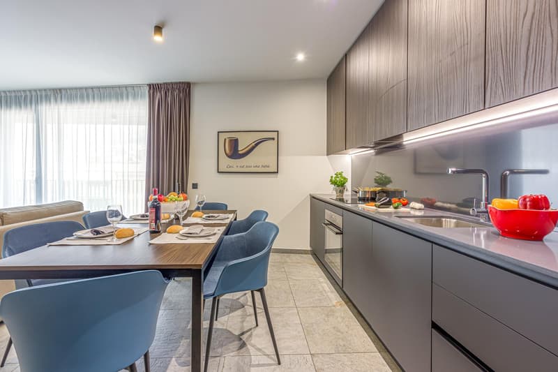 Dining table set for 6, modern cabinets, sink with faucet, countertop with appliances, gas stove