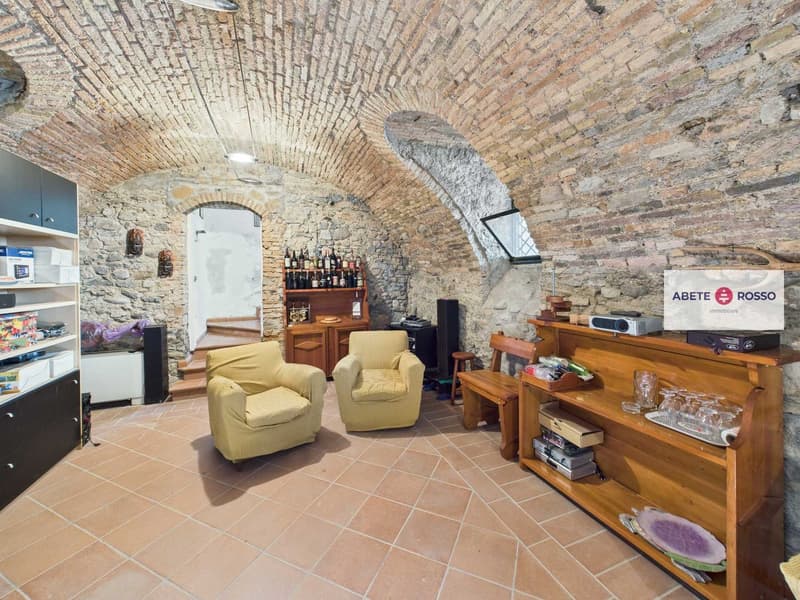 stone wall, arched ceiling, wooden chair, wooden cabinet, wooden shelf