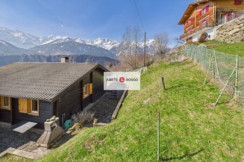 wooden house, chimney, windows, table, mountains in the background
